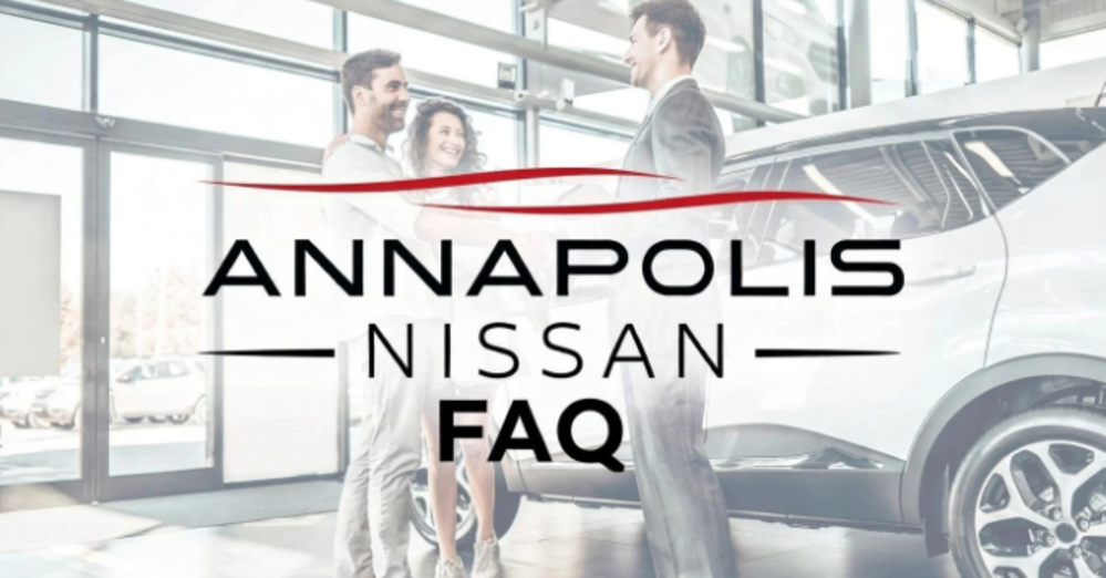 Annapolis Nissan showroom staff greeting customers near a white SUV