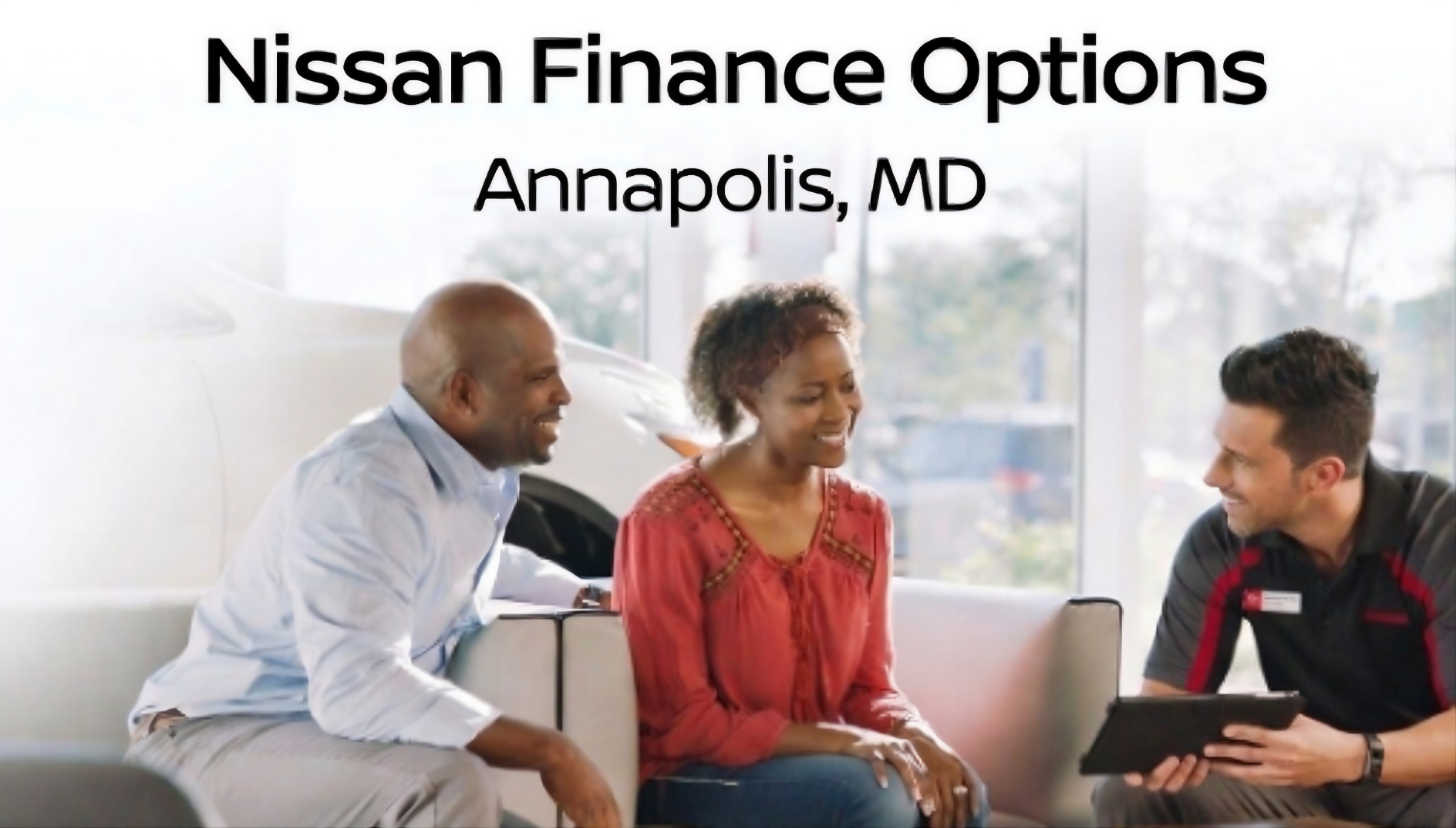 Two Annapolis Nissan customers sitting down with the sales team to discuss their financing options
