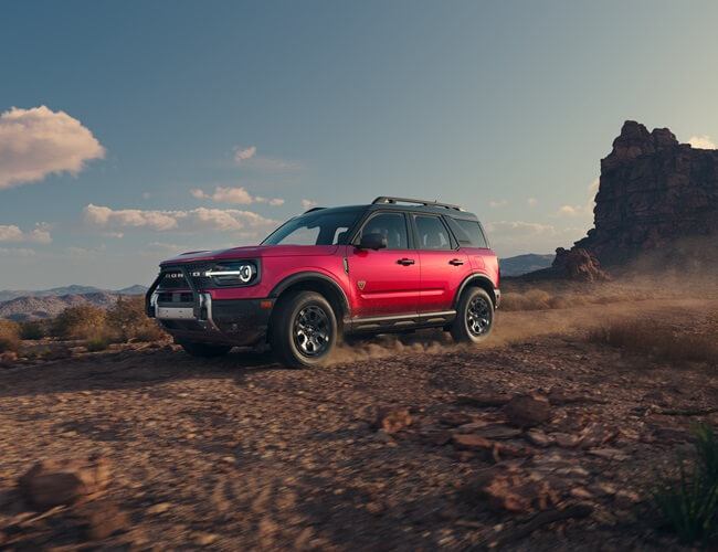 Used Ford Bronco Sport driving on dirt path from used car dealer near Palm River‑Clair Mel FL
