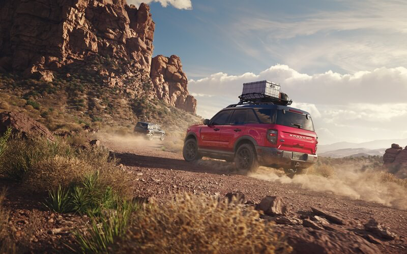 Ford Bronco Sport driving up dirt hill road from Ford Dealer near Palm River-Clair Mel FL