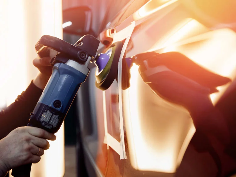 Close up view of mechanic working on vehicle repair at body shop in Tampa FL