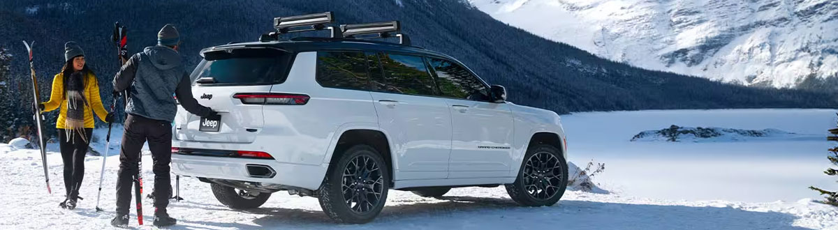 White Jeep Grand Cherokee SUV Parked in Nature on a Snowy Day