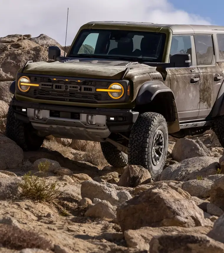 A 2025 Ford Bronco SUV rock-crawling in the desert.