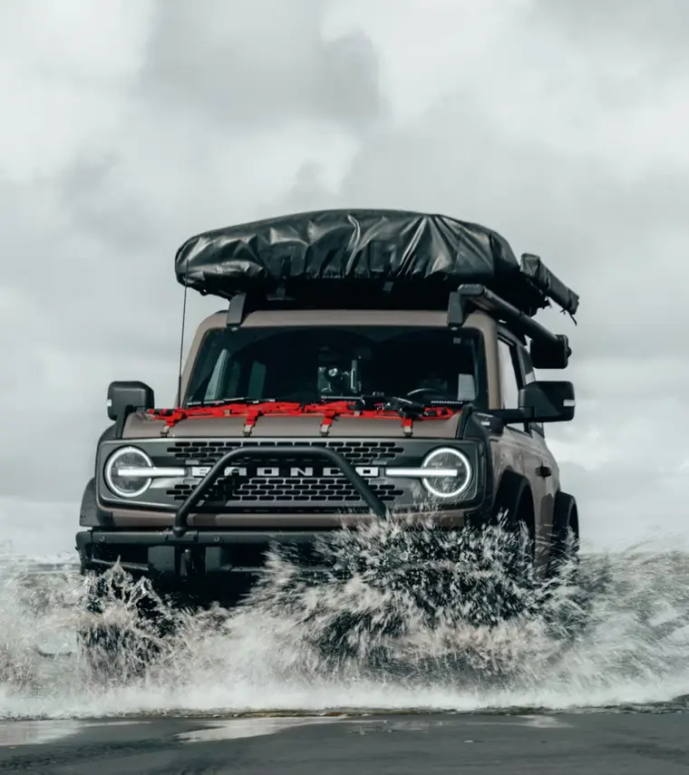 A 2025 Ford Bronco SUV driving in water.