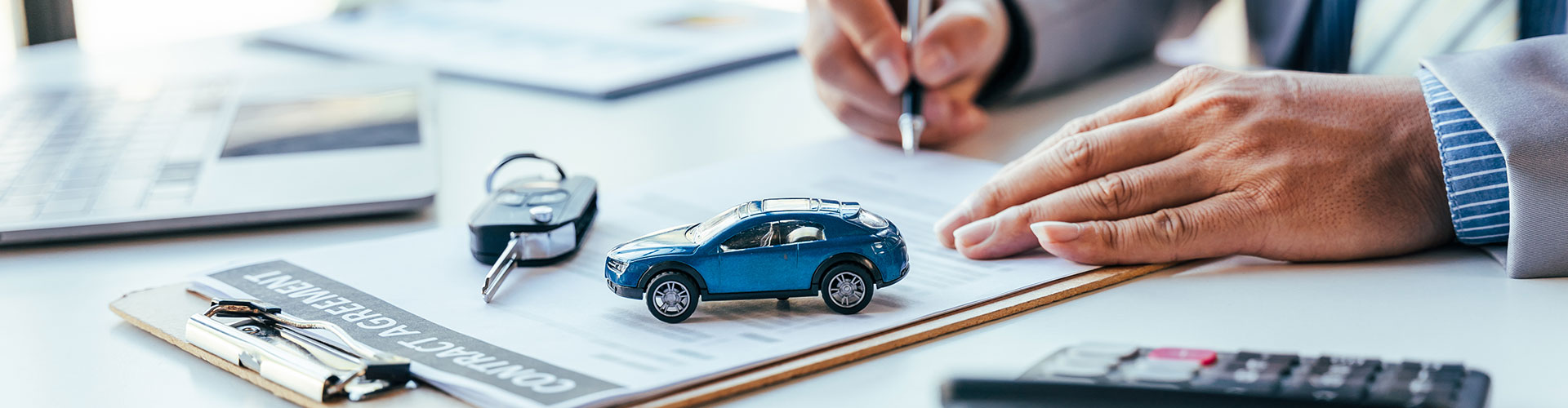 Man signing agreement | Fury Motors Stillwater CDJR