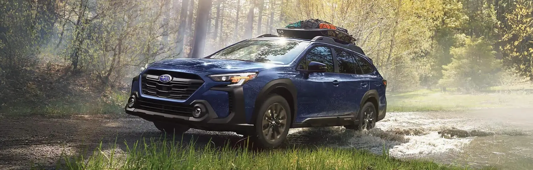 2025 Subaru Outback driving in the forest
